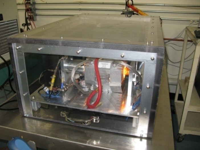 Figure 4.  Rotating Heat Pipe Test Apparatus during RHP testing (the glow is from the IR lamps supplying heat to the heat pipe).