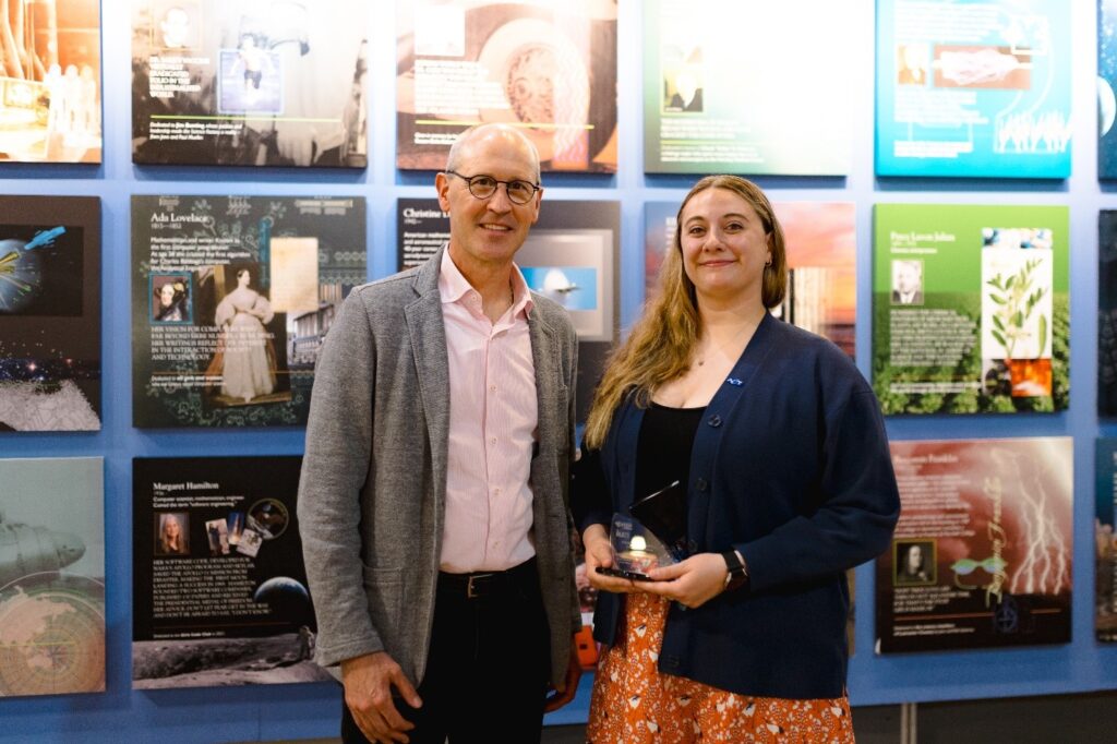 Photograph of Lancaster county STEM alliance representative and ACT representative Ellie Seber holding the award received at the ceremony.