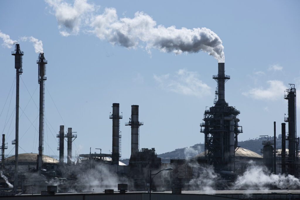 Oil refining causing global warming with harmful greenhouse gas emissions.