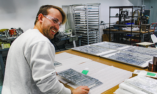 Photo of an ACT technician checking components for quality