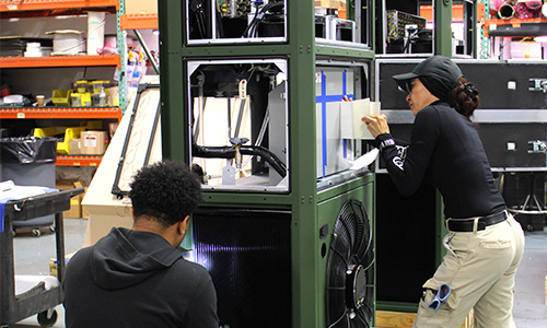 Photo of people working on an Environmental Control Unit